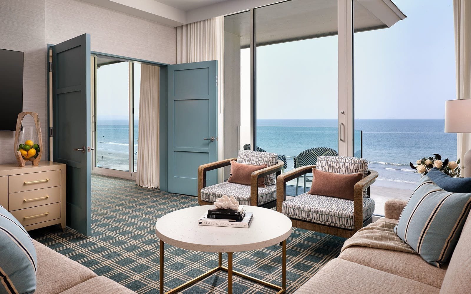 Oceanfront suite living room with sofa and balcony view at Hotel del Coronado